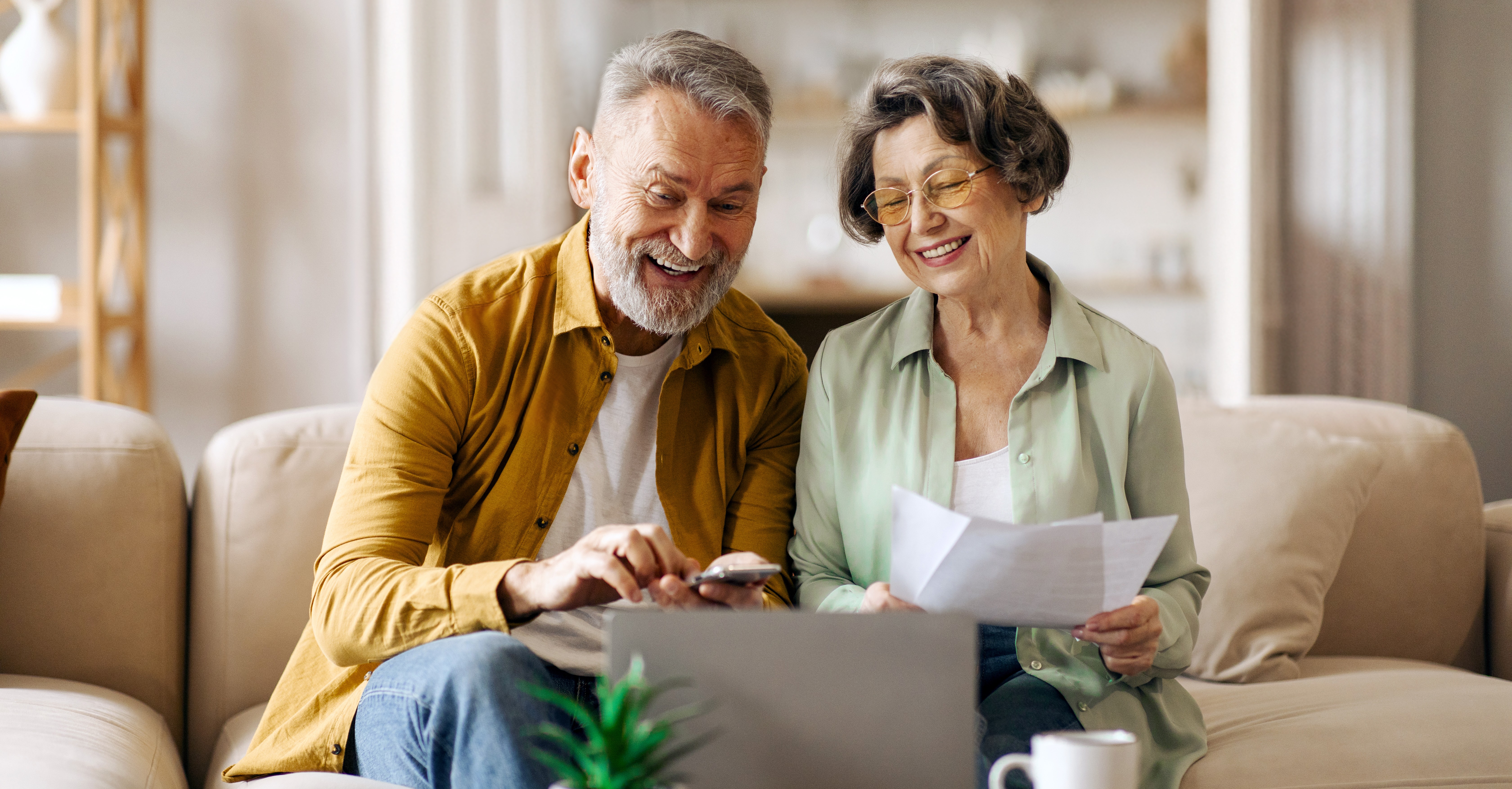 happy-senior-couple-with-laptop-papers-planning-family-budget-together-calculating-spends.jpg